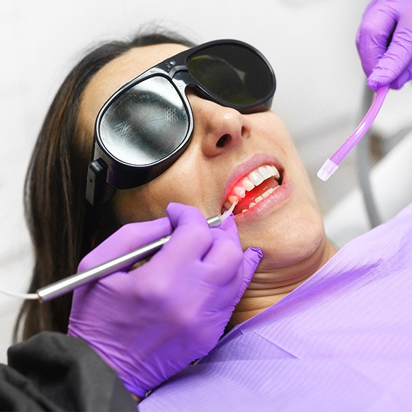 Woman receiving laser treatment for crown lengthening