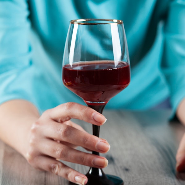 person holding a glass of wine