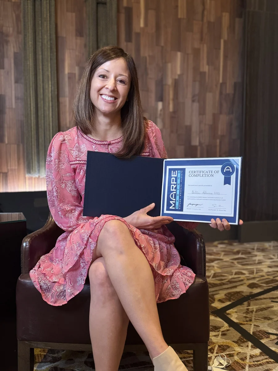 Dr. Billie Adams holding her MARPE training certificates