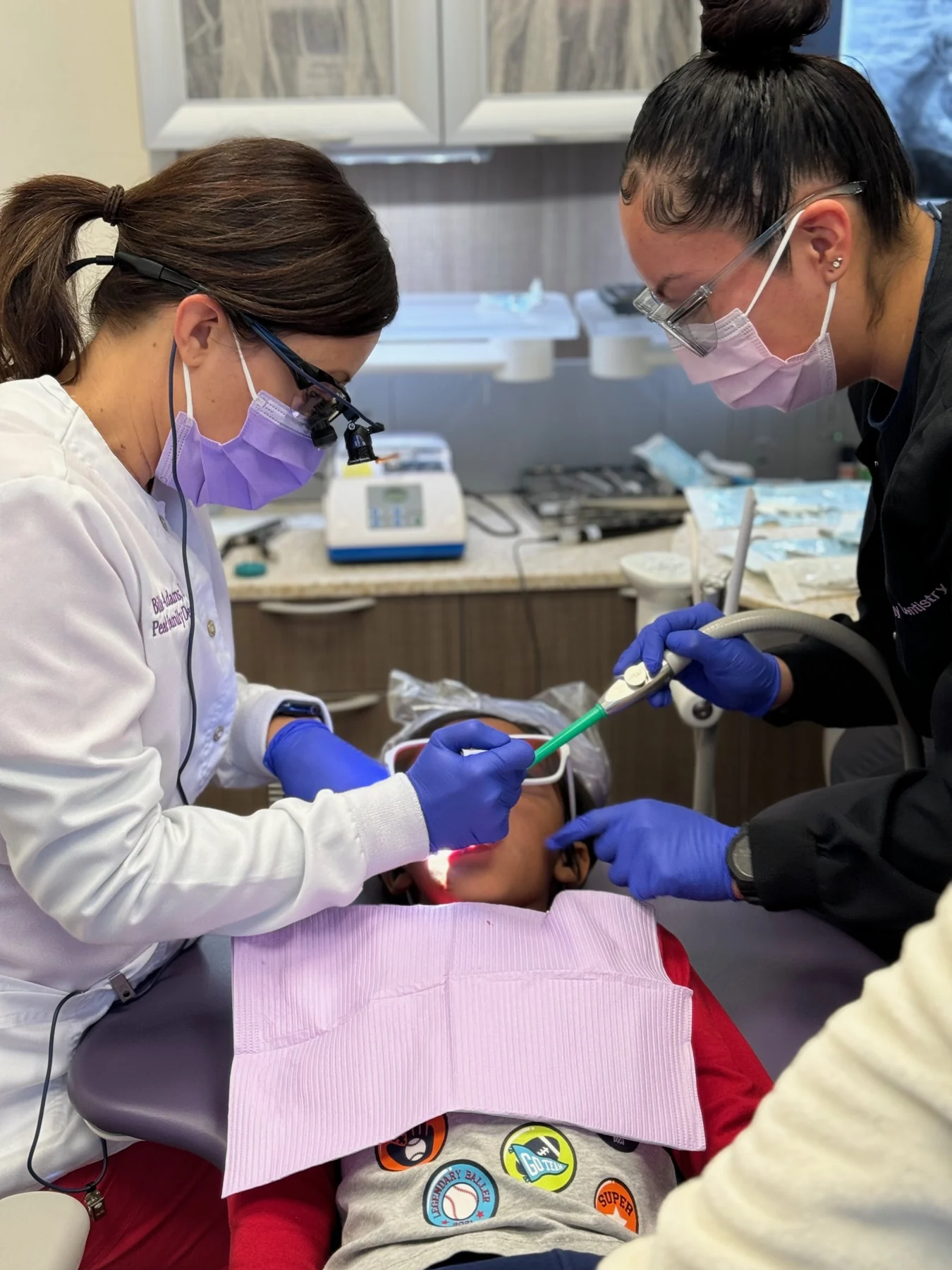 Dr. Adams and a team member providing dental care
